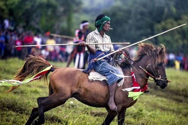 Pasola festival horse riders in traditional clothing, Sumba Indonesia